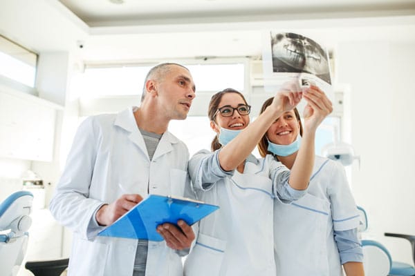 Dentists looking at X-ray